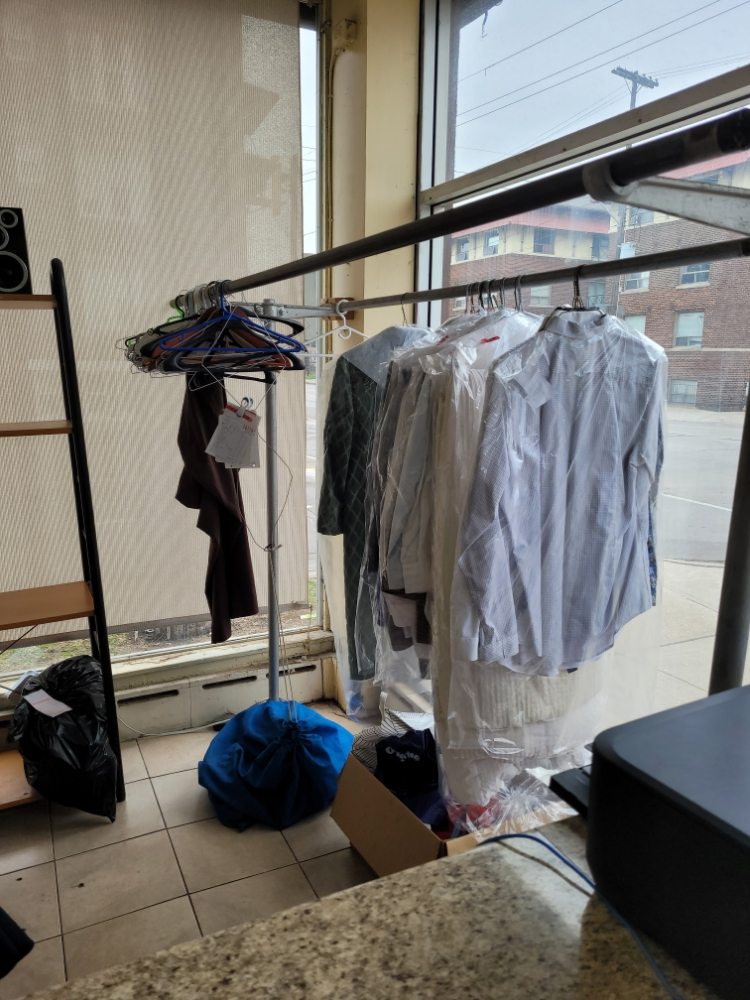 Dry cleaning drop-off rack with clothes ready for pickup